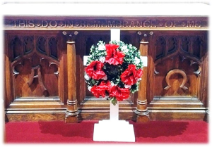 remembrance wreath on cross standing before altar